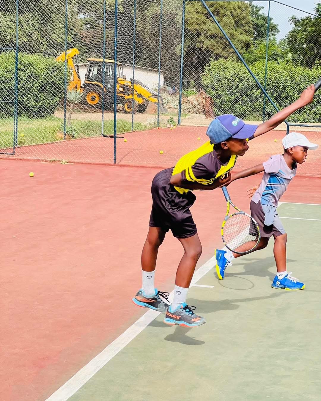 Junior players practicing groundstrokes