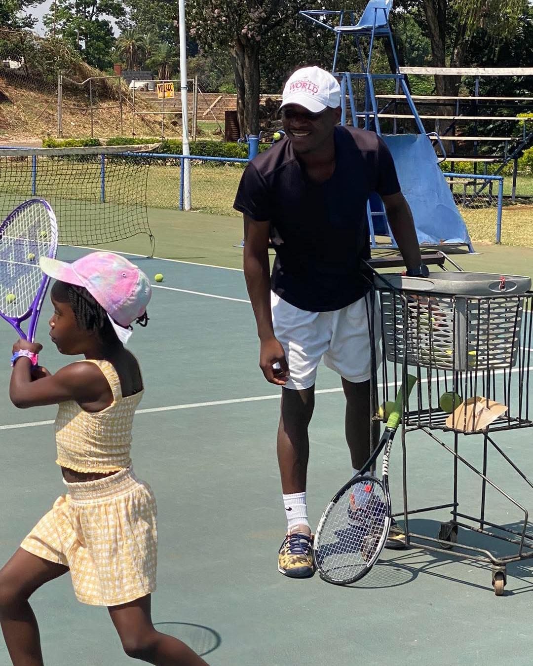 Coach demonstrating technique to young players