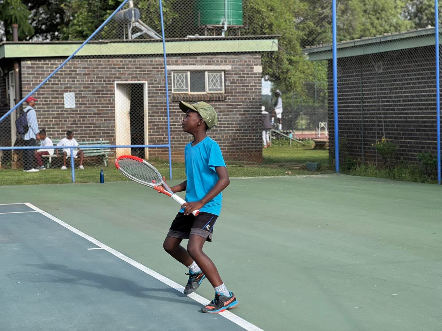 Coach Aaron Chigoche with students