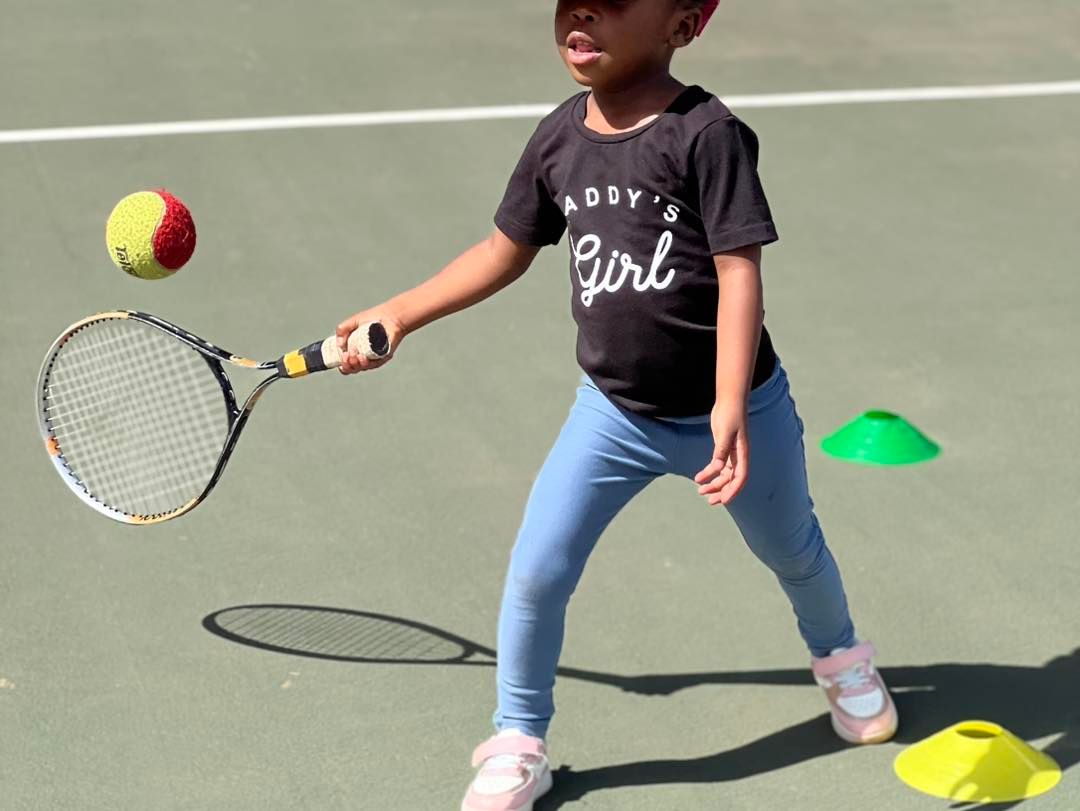 Coach demonstrating volley technique